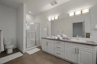 a bathroom with a toilet and a sink and a shower at Charming 3 Bedrooms Home with BBQ- Deck- Fenced yard-Near WEM & River Valley in Edmonton