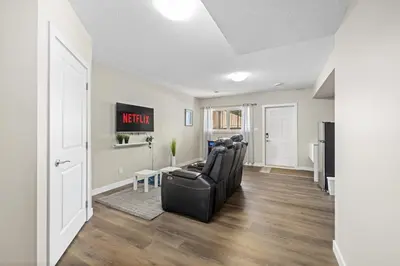 a living room with a black couch and a table at 1 bedroom in Edmonton
