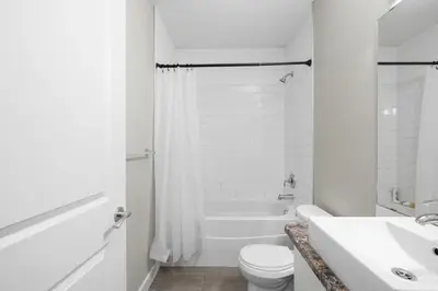 a white bathroom with a toilet and a sink at 1 bedroom in Edmonton