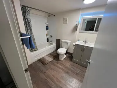 a bathroom with a tub and a toilet and a sink at Nanaimo Nest in Nanaimo
