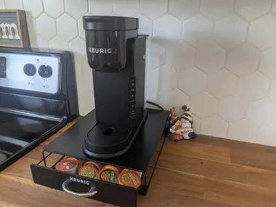 a coffee maker sitting on a counter next to an oven at A Little R and R Private Sauna Cold and Hot Plunge in Calgary