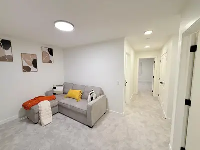 a living room with a gray couch and yellow pillows at Casa Koko in Calgary