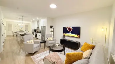 a living room and kitchen with a couch and a table at Casa Koko in Calgary