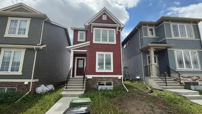 a group of three houses in a row at La Maison de Koko in Calgary