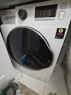 a white washing machine sitting in a room at Basement Suite Private Entry Fort McMurray in Fort McMurray