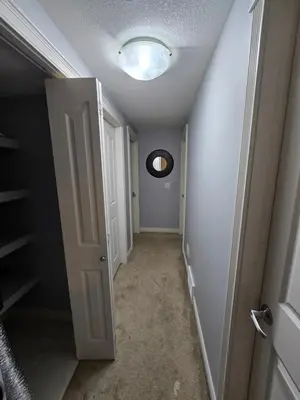 a hallway with a white door and a round window at Basement Suite Private Entry Fort McMurray in Fort McMurray