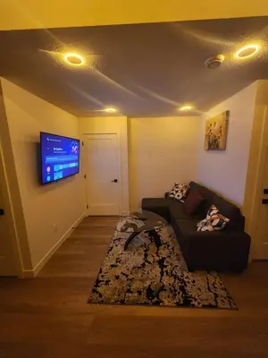 a living room with a couch and a flat screen tv at Home in Calgary in Calgary