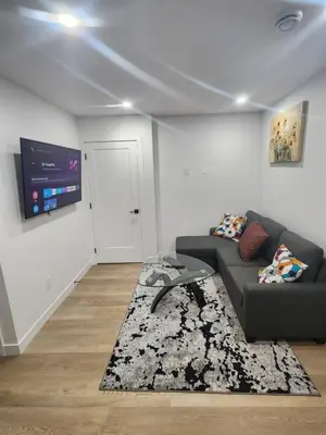 a living room with a couch and a flat screen tv at Home in Calgary in Calgary