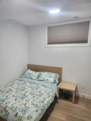 a bedroom with a bed and a small table at Home in Calgary in Calgary