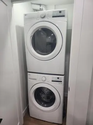 a white washer and dryer in a room at Home in Calgary in Calgary