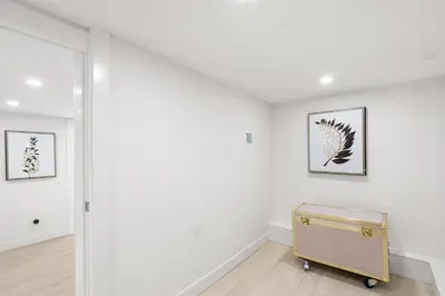 a room with white walls and a yellow suitcase at Callister BNB in Vancouver