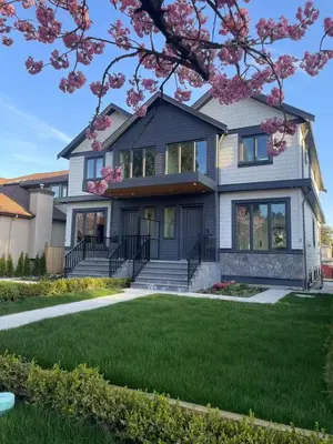 a house with pink flowers on the lawn at 3 bed duplex in Kitsilano 10 min to airport and 10 min to downtown in Vancouver