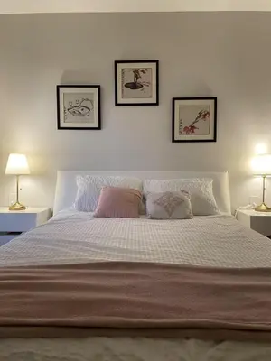 a bedroom with a large bed with two lamps at 3 bed duplex in Kitsilano 10 min to airport and 10 min to downtown in Vancouver