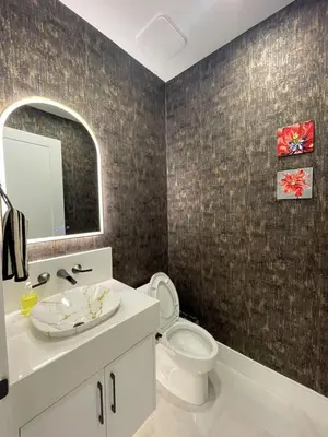 a bathroom with a toilet and a sink and a mirror at 3 bed duplex in Kitsilano 10 min to airport and 10 min to downtown in Vancouver