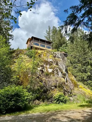 a house sitting on top of a hill at Eagles Nest - epic blufftop cabin Squamish in Upper Squamish