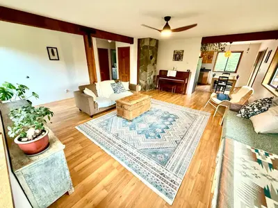 a living room with a couch and a table at Eagles Nest - epic blufftop cabin Squamish in Upper Squamish