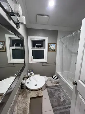 a bathroom with a sink and a toilet and a tub at Vancouver Comfort Home 10 min to YVR airport, Close to Downtown in Vancouver