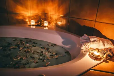 a bathroom with a bath tub filled with debris at Elowen Suites Downtown in Drumheller