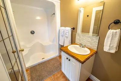 a bathroom with a sink and a shower at Elowen Suites Downtown in Drumheller