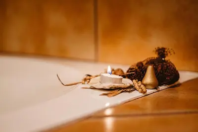 a candle sitting on a counter next to a pumpkin at Elowen Suites Downtown in Drumheller