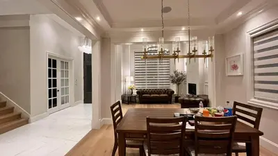 a dining room and living room with a table and chairs at Vancouver Richmond Villa 41 in Richmond