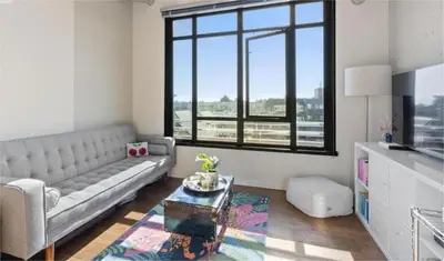 a living room with a couch and a table at Downtown one bedroom apartment 2 in Victoria
