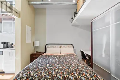 a bedroom with a bed and a desk in a room at one private room in Victoria