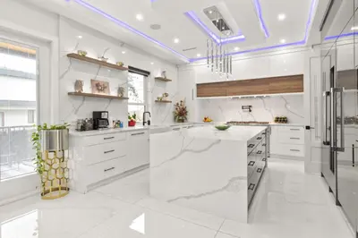 a kitchen with white cabinets and a large island at Spacious 6BR Entire Home Sleeps 14 Private Parking Pet-Friendly Near Vancouver in Surrey