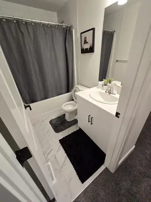 a bathroom with a sink and a toilet and a shower at Modern Comfort - With AC in Calgary