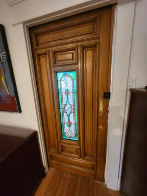 a wooden door with a stained glass window at Lakeview Suite by Trout Lake in Vancouver