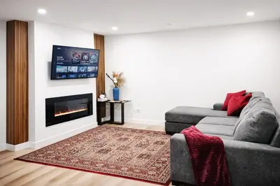 a living room with a couch and a fireplace at 1 BR suite near WEM, with fast WiFi and Equipped kitchen in Edmonton