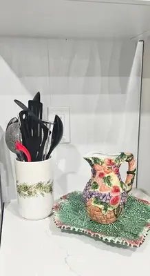 a container of utensils and a vase on a counter at 1 BR suite near WEM, with fast WiFi and Equipped kitchen in Edmonton