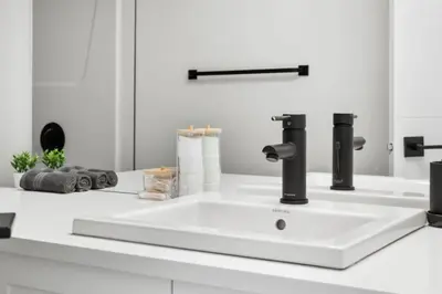a white sink in a white bathroom at Two Bedroom Townhouse with AC Garage Parking and Wifi in Calgary