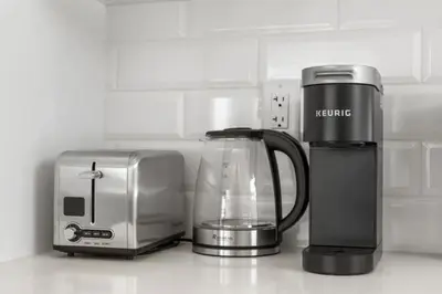 a coffee maker and a toaster on a kitchen counter at Two Bedroom Townhouse with AC Garage Parking and Wifi in Calgary