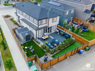 an overhead view of a house with a backyard at Large Luxury Home Featuring Entertain Room with Karaoke Air Hockey and Pool Table in Calgary