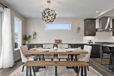 a dining room and kitchen with a table and chairs at Large Luxury Home Featuring Entertain Room with Karaoke Air Hockey and Pool Table in Calgary