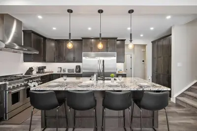 a kitchen with a large table with chairs in it at Large Luxury Home Featuring Entertain Room with Karaoke Air Hockey and Pool Table in Calgary