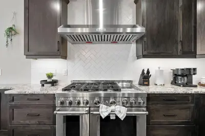 a kitchen with a stove with a towel on the oven at Large Luxury Home Featuring Entertain Room with Karaoke Air Hockey and Pool Table in Calgary