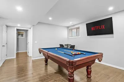 a pool table in the middle of a room at Large House with Billiards, 5 Bedrooms, Garage Parking & Free Banff Access in Calgary