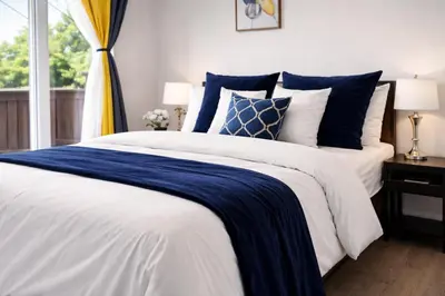 a bedroom with a blue and white bed and a window at Bright 3-Bed Retreat Near the Zoo and Downtown in Calgary