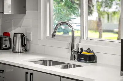 a kitchen counter with a sink and a window at Bright 3-Bed Retreat Near the Zoo and Downtown in Calgary