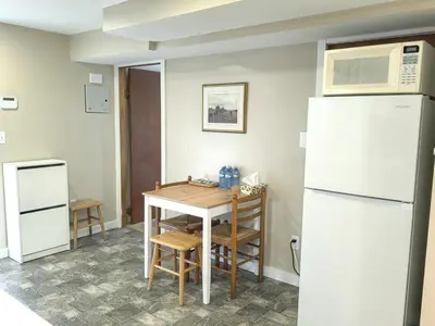 a kitchen with a table and a white refrigerator at Private Cozy 2bdrm Sleep5pp Metrotown! Free Parking! Self Check-in! in Burnaby