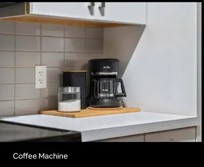 a coffee maker on a counter in a kitchen at Brand new suite with parking pad at the back in Calgary