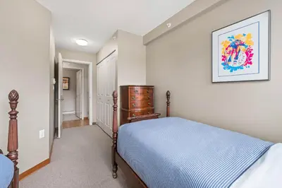 a bedroom with a bed and a picture on the wall at 2BR in Nicklaus North, Mountain Views, Bright and Spacious, Tranquil Location in Whistler