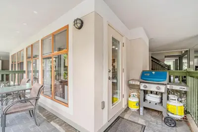 a home kitchen with a stove and a table at 1BR in Northstar, Village Location, Hot Tub, Gas Fireplace, Secure Parking, Ski Storage in Whistler