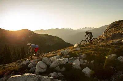 two people riding bikes on top of a mountain at 1BR in Northstar, Village Location, Hot Tub, Gas Fireplace, Secure Parking, Ski Storage in Whistler