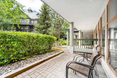 a patio with a table and chairs on a balcony at 1BR in Northstar, Village Location, Hot Tub, Gas Fireplace, Secure Parking, Ski Storage in Whistler