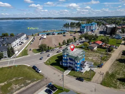 an aerial view of a city with a red balloon at Lakefront Lookout 1BR Condo on Lakeshore Drive in Sylvan Lake
