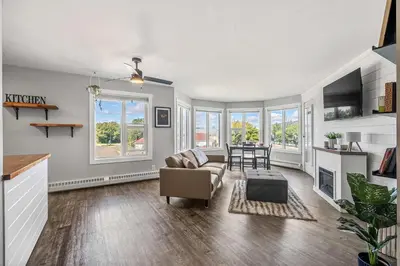 a living room with a couch and a table at Lakefront Lookout 1BR Condo on Lakeshore Drive in Sylvan Lake