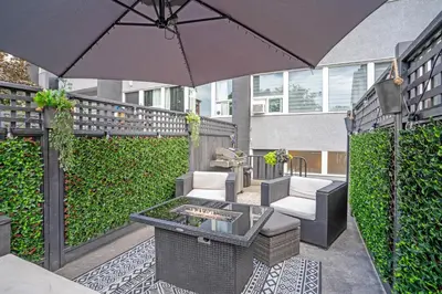 a patio with a table and an umbrella at The Rosemead Suite in Kelowna